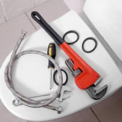 Plumber's tools on a toilet