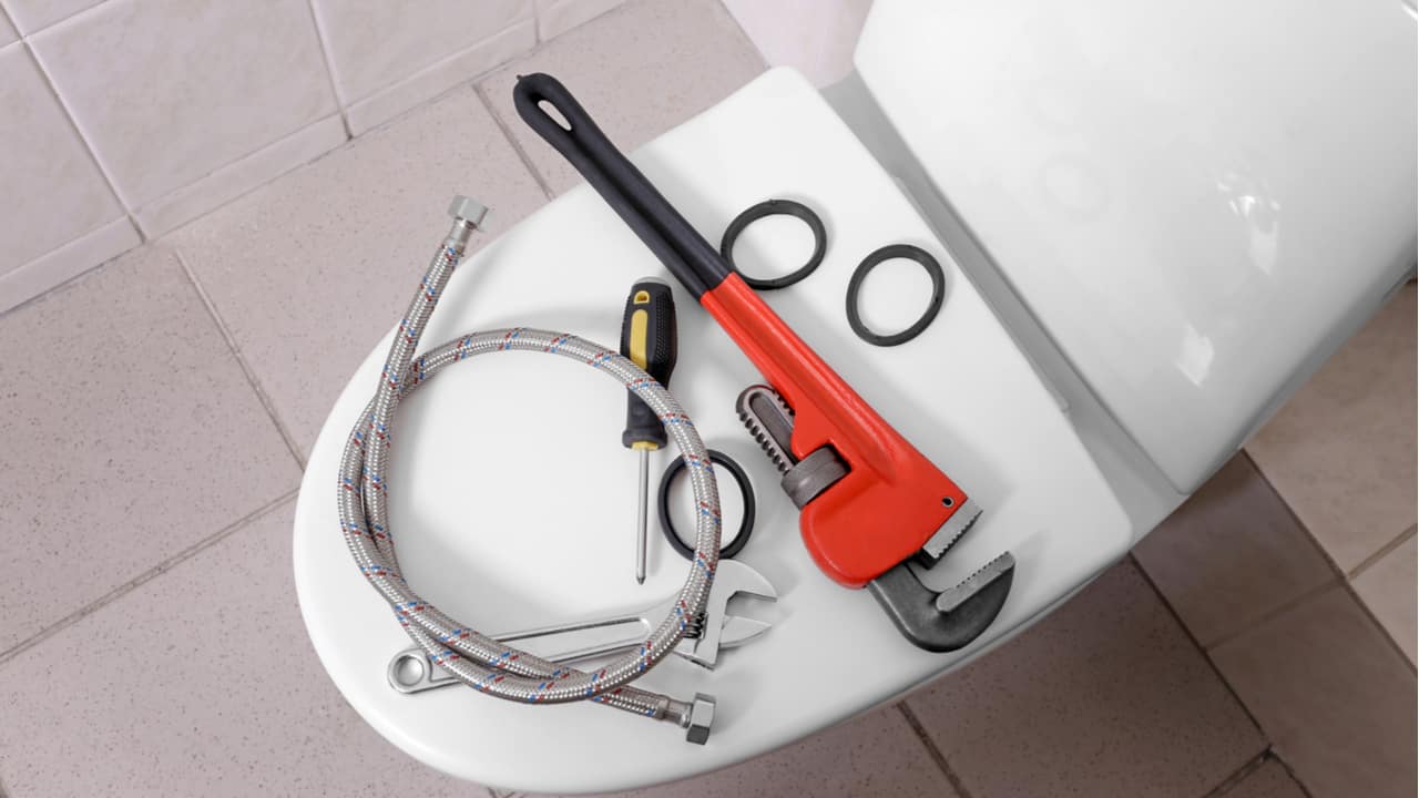 Plumber's tools on a toilet