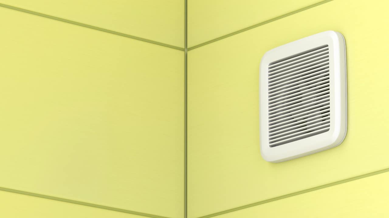 Bathroom fan on yellow wall