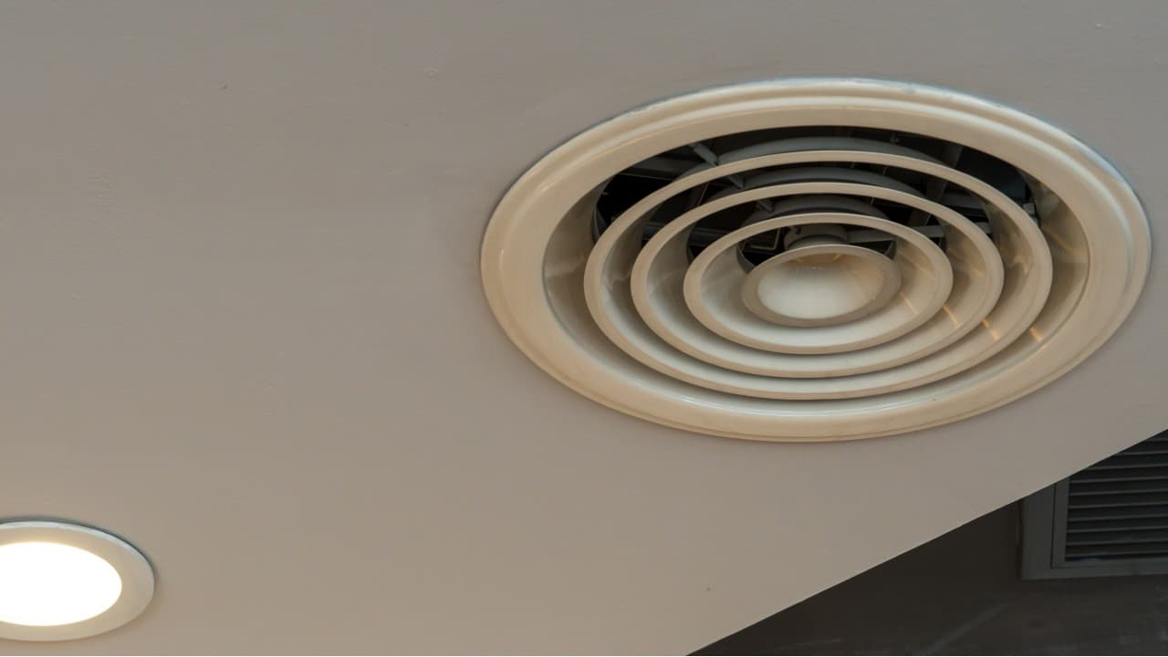 Round bathroom fan in a ceiling